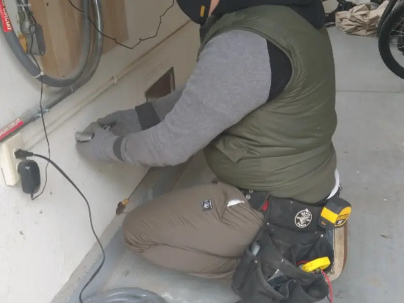 Electrician performing outlet wiring in a Cynthiana garage